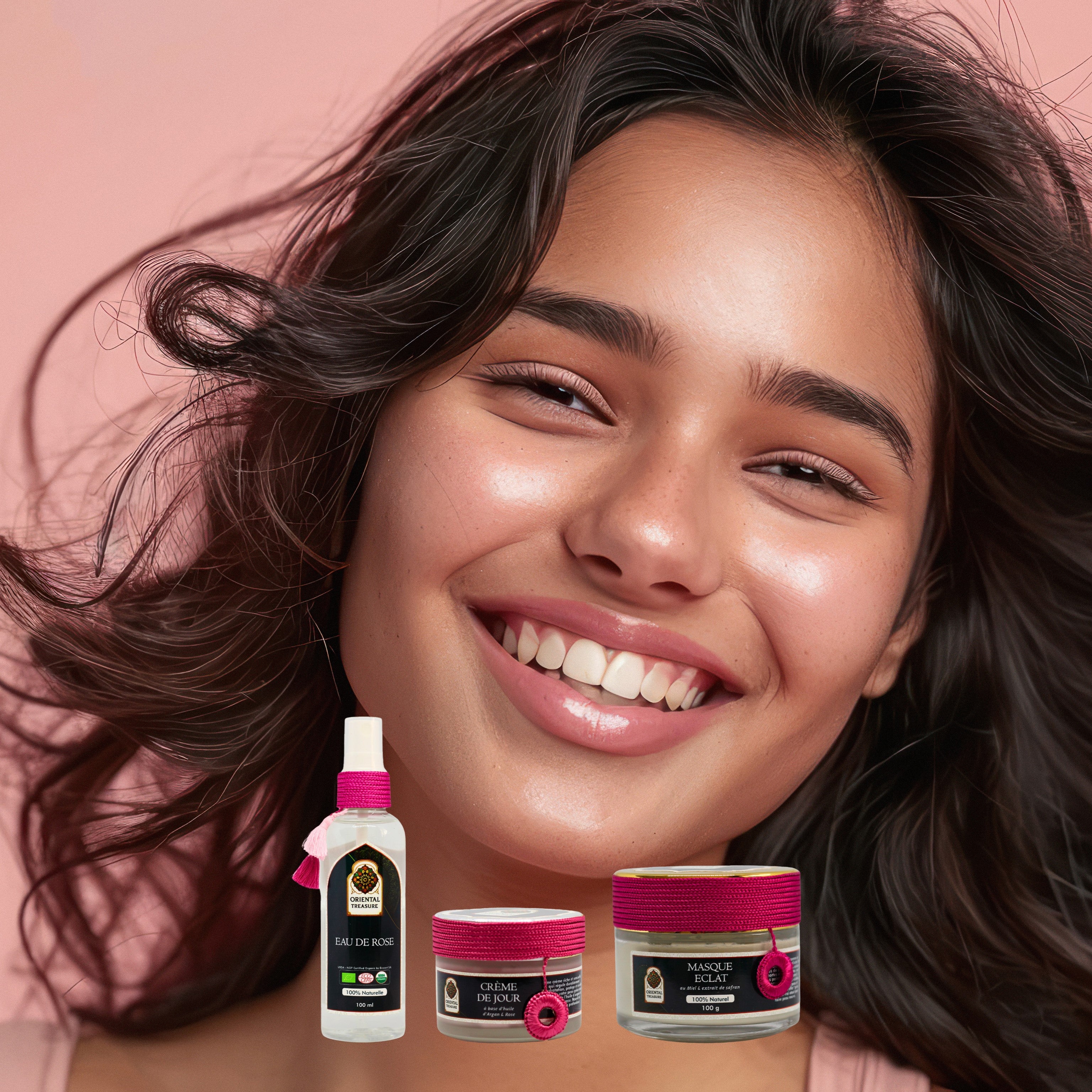 Une jeune belle femme souriante sur fond rose. En premier plan des produits de la gamme Soin Anti Imperfection de la marque Oriental Treasure