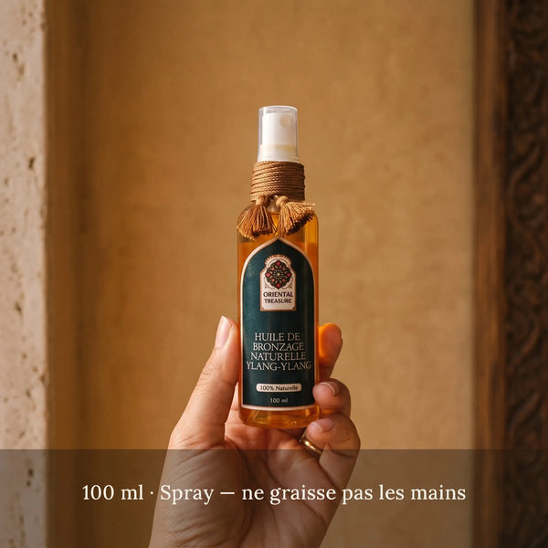 Flacon d'huile de bronzage carotte et argan 100 ml en main